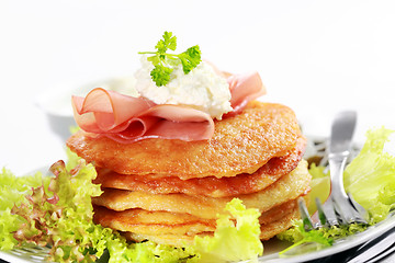 Image showing Small potato pancakes with salad