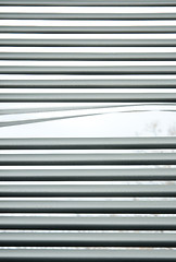 Image showing Peeking through venetian blinds