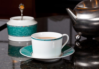 Image showing Tea poured from stainless steel teapot