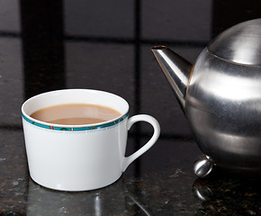 Image showing Tea poured from stainless steel teapot