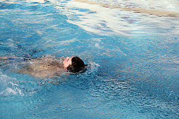 Image showing a man swimming backstroke in pool