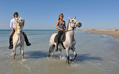 Image showing horseback riding on the beach