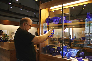 Image showing Man bying Coblat Blue Glass.
