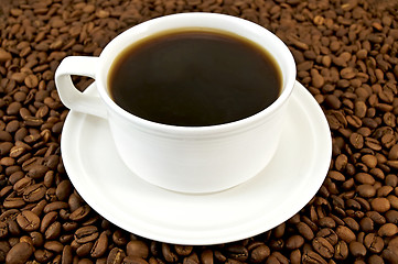 Image showing Coffee in white cup on coffee beans