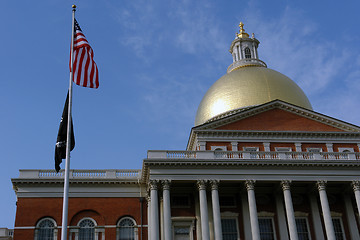 Image showing American Flag with POW MIA in front of State House