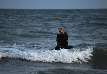 Image showing riding woman in sea by night