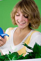 Image showing girl watering flowers