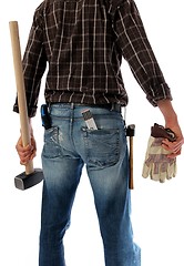 Image showing Construction worker with sledge hammer from behind