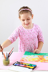 Image showing Cute girl painting with watercolor