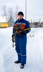 Image showing The worker-electrician  in blue overalls 