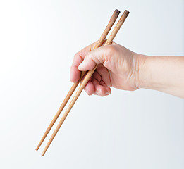 Image showing hand using chopsticks