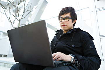 Image showing man using computer outdoor