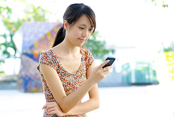 Image showing woman sms on mobile phone