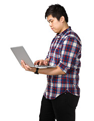 Image showing Young asian man using laptop computer