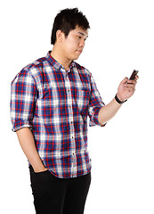 Image showing man sms on cell phone