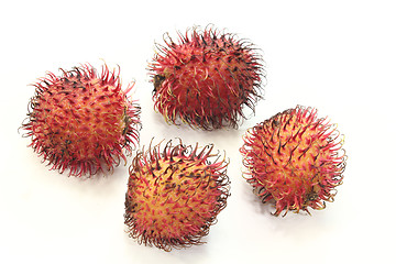 Image showing four red rambutan