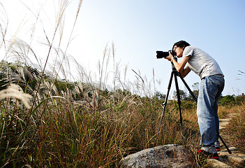 Image showing photographer taking photo in wild