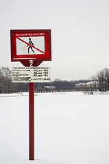 Image showing Frozen lake in winter and warning sign