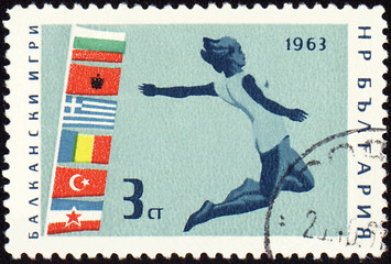 Image showing Jumping athlete on post stamp