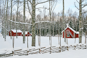 Image showing Swedish winter landscape with red wooden houses