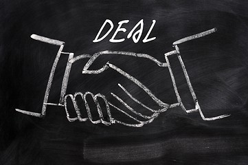 Image showing Business deal written on a blackboard background with handshaking