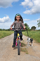 Image showing girl withe dog on bicycle