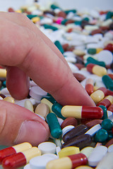 Image showing hand grabbing pills