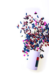 Image showing pills spilling out of container 