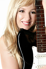 Image showing Female leaning on her guitar