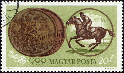 Image showing Sportsman riding horse and Olympic medal on post stamp