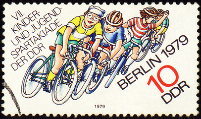 Image showing Group of young cyclists on post stamp