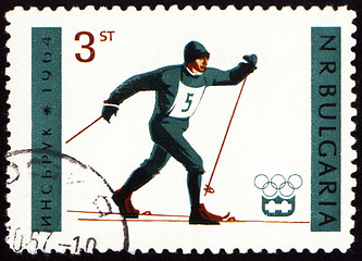 Image showing Running skier on post stamp