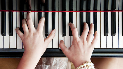 Image showing Hands on piano keys