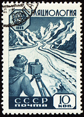 Image showing Researcher with device in mountain on post stamp