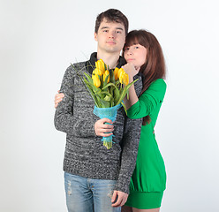 Image showing happy young couple with bouquet flowers