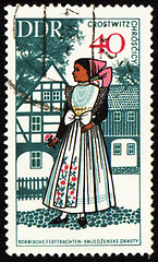 Image showing Young woman in national costume on post stamp