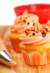 Image showing Halloween cupcakes being frosted