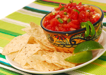 Image showing Tortilla chips with salsa and lime