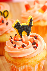 Image showing Halloween cupcakes being frosted