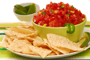 Image showing Tortilla chips with salsa and lime