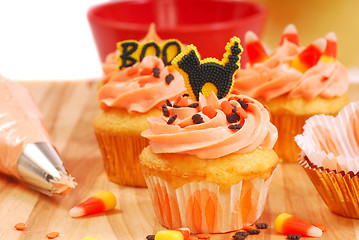 Image showing Halloween cupcakes being frosted