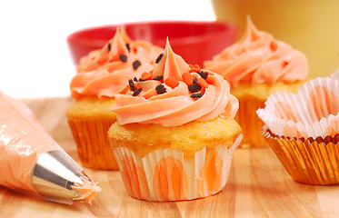 Image showing Halloween cupcakes being frosted