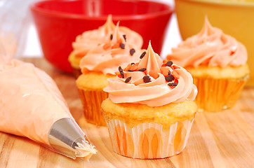 Image showing Halloween cupcakes being frosted