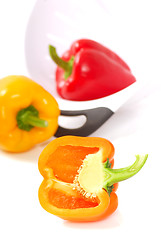 Image showing Orange, yellow and red bell peppers with a strainer