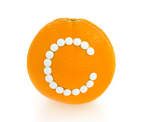 Image showing Orange with vitamin c pills over white background