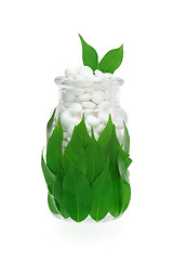 Image showing Herbal supplement pills and fresh leaves in glass