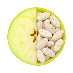 Image showing Close up of apple and pills isolated 