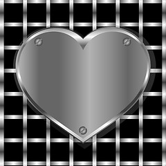 Image showing Brushed metal heart on a perforated metal background