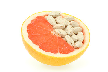 Image showing Close up of red grapefruit and pills isolated