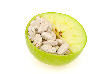 Image showing Close up of apple and pills isolated 